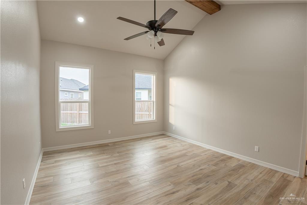 2618 Max Street Harlingen, TX 78552 - Photo 17 of 35 Spacious room with a vaulted ceiling, exposed wood beam, and wood-finish flooring