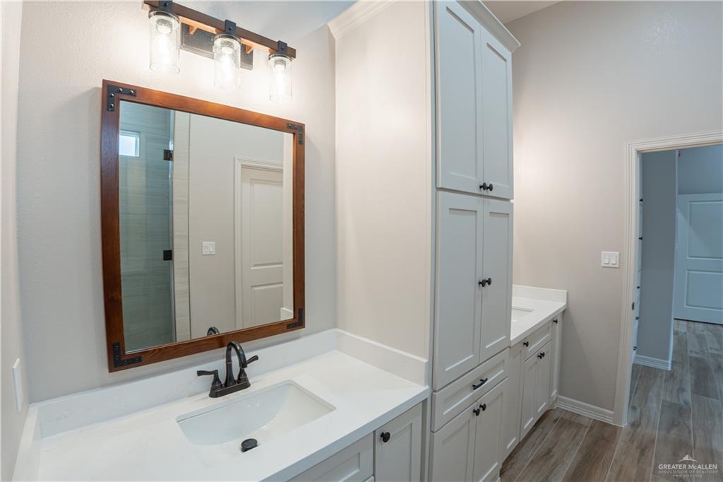 2618 Max Street Harlingen, TX 78552 - Photo 21 of 35 Dual vanity with white shaker-style cabinetry, white countertops, and integrated sinks