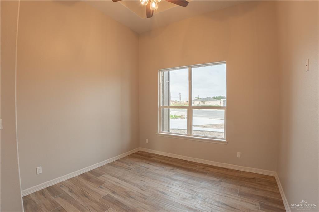 2618 Max Street Harlingen, TX 78552 - Photo 25 of 35 Spacious room with high vaulted ceilings, wood-finish flooring, and a large multi-pane window