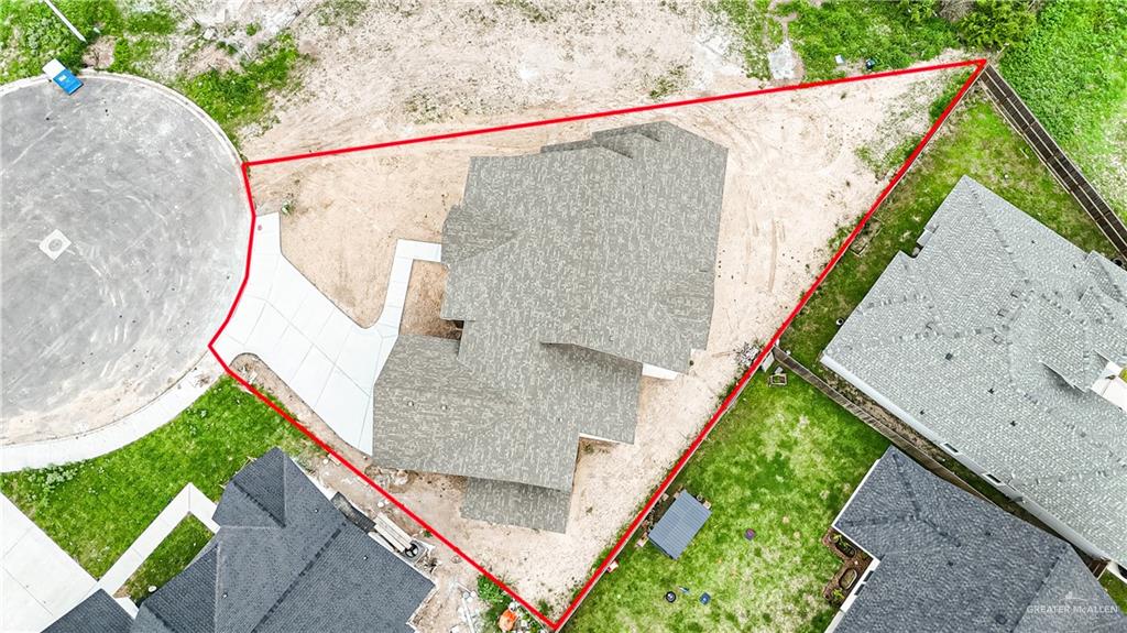 2618 Max Street Harlingen, TX 78552 - Photo 33 of 35 Aerial perspective showcasing the property's footprint with a red outline, featuring a newly constructed residence with a multi-gabled shingle roof