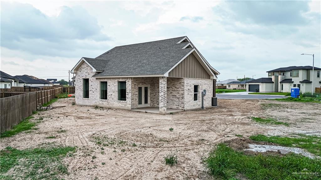 2618 Max Street Harlingen, TX 78552 - Photo 34 of 35 New construction home featuring light-colored brick exterior, a dark shingle roof, and a covered back patio