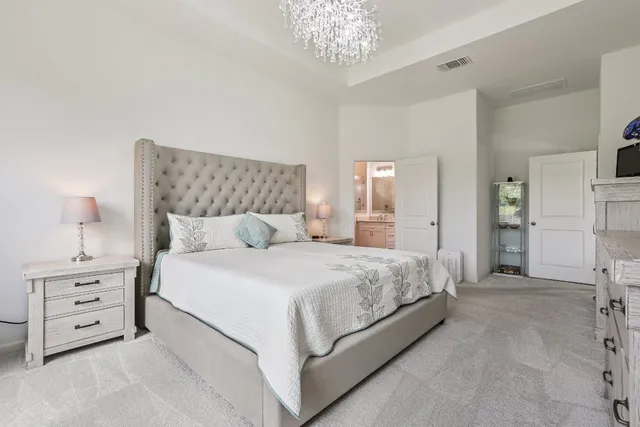 a spacious bedroom with a bed and a couch