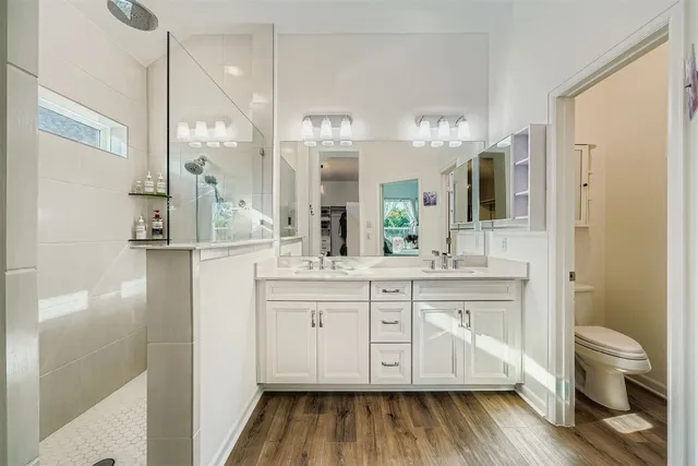 a bathroom with a double vanity sink and a mirror