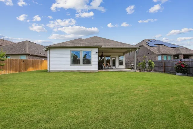a front view of house with yard and outdoor seating