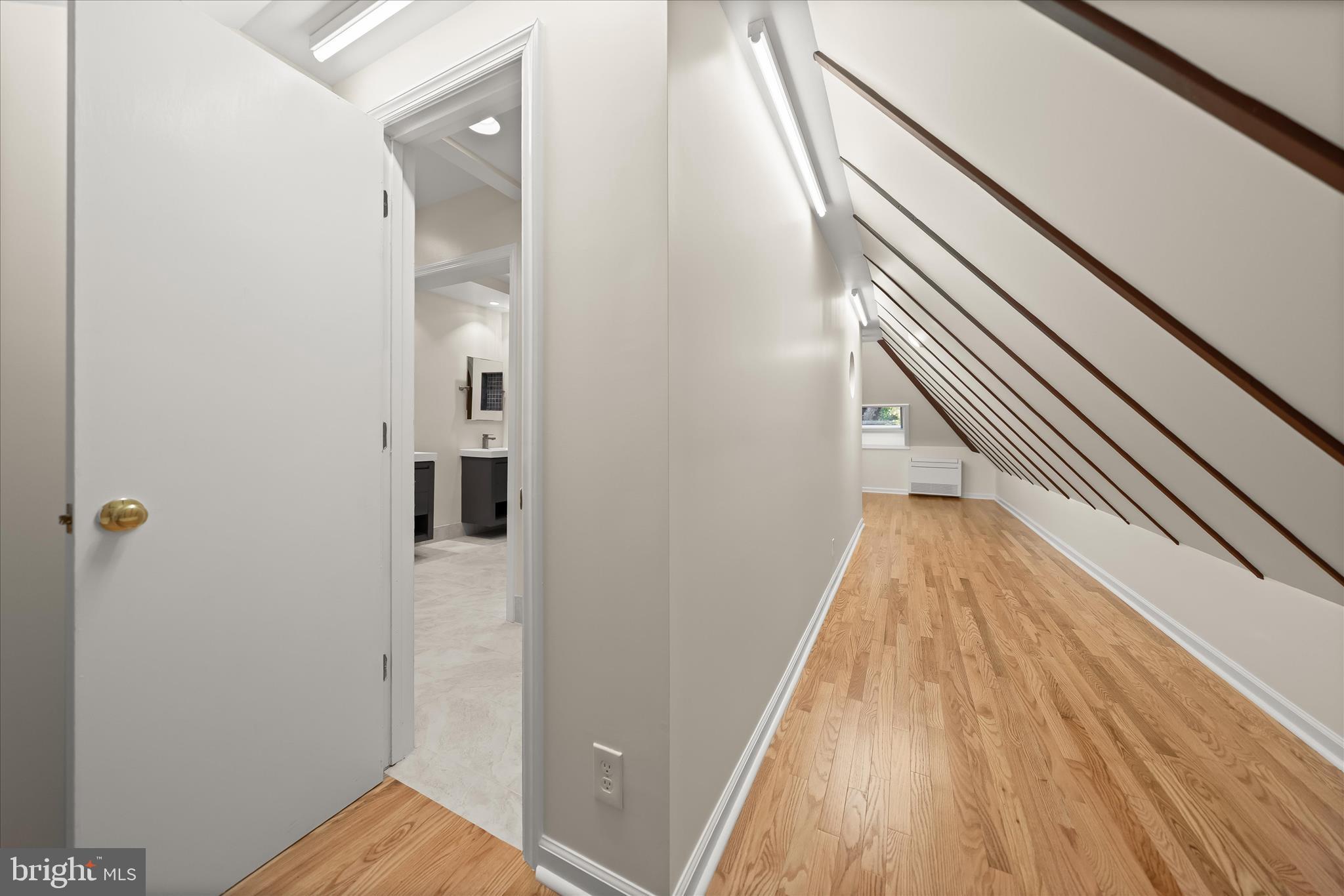 5104 Scarsdale Road Bethesda, MD 20816 - Photo 40 of 68 a view of a hallway with wooden floor and staircase