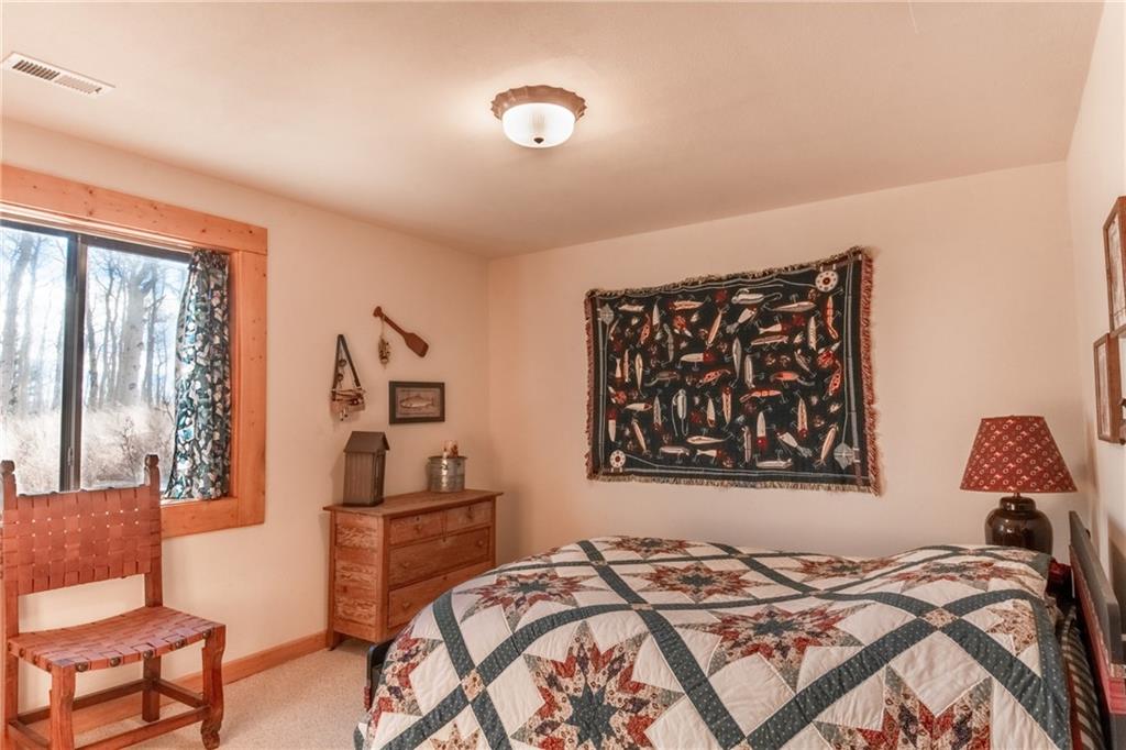 165 Sheep Ridge Road Fairplay, CO 80440 - Photo 17 of 33 a bedroom with a bed and a window