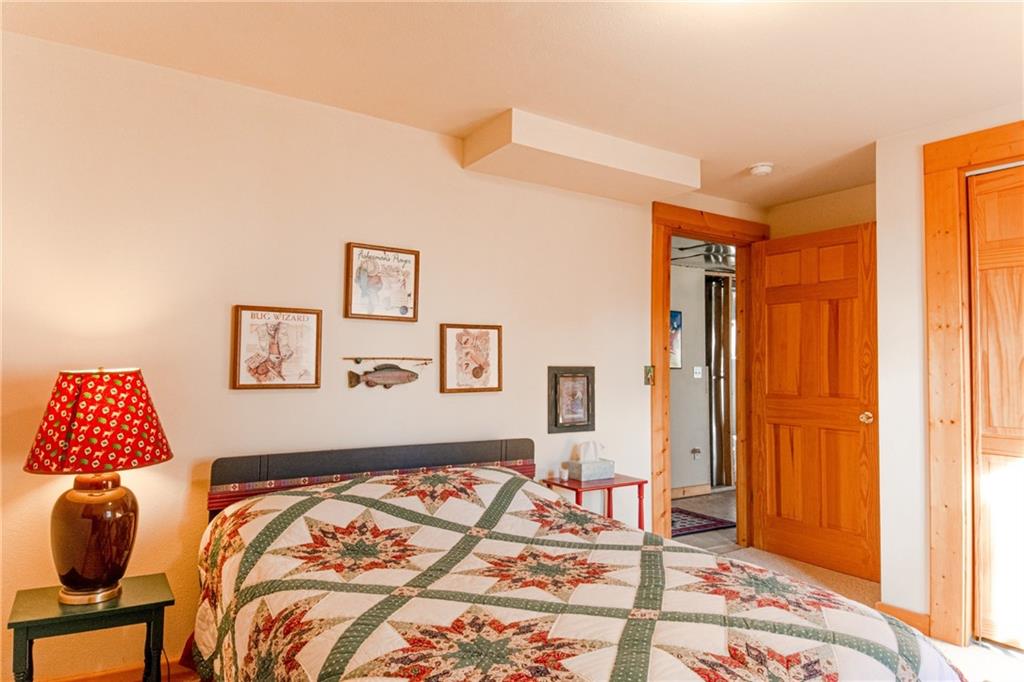 165 Sheep Ridge Road Fairplay, CO 80440 - Photo 20 of 33 a bedroom with a bed and a painting on the wall