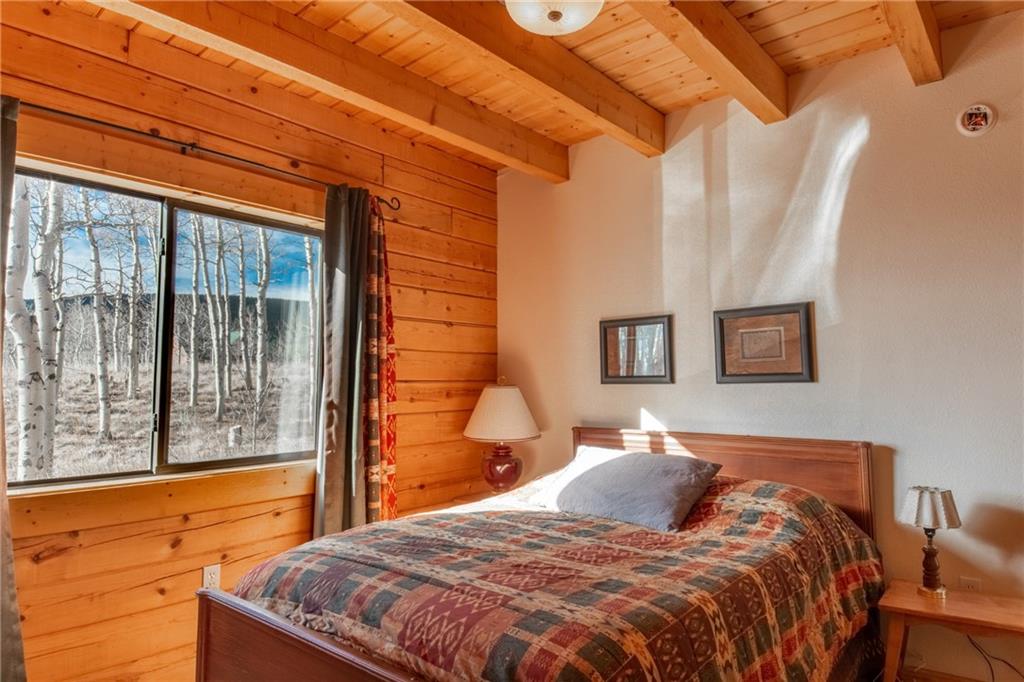 165 Sheep Ridge Road Fairplay, CO 80440 - Photo 6 of 33 a bedroom with a bed and a large window
