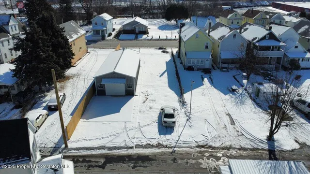 a view of a house with wooden fence