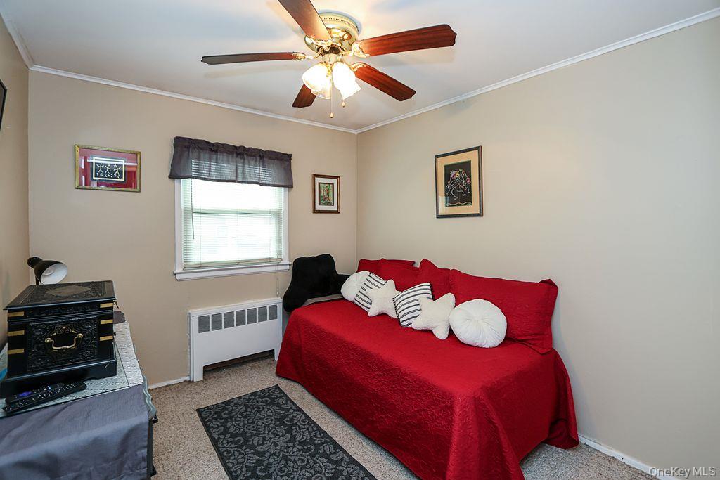 64 Conlon Road Roosevelt, NY 11575 - Photo 11 of 19 a bedroom with a bed and a window