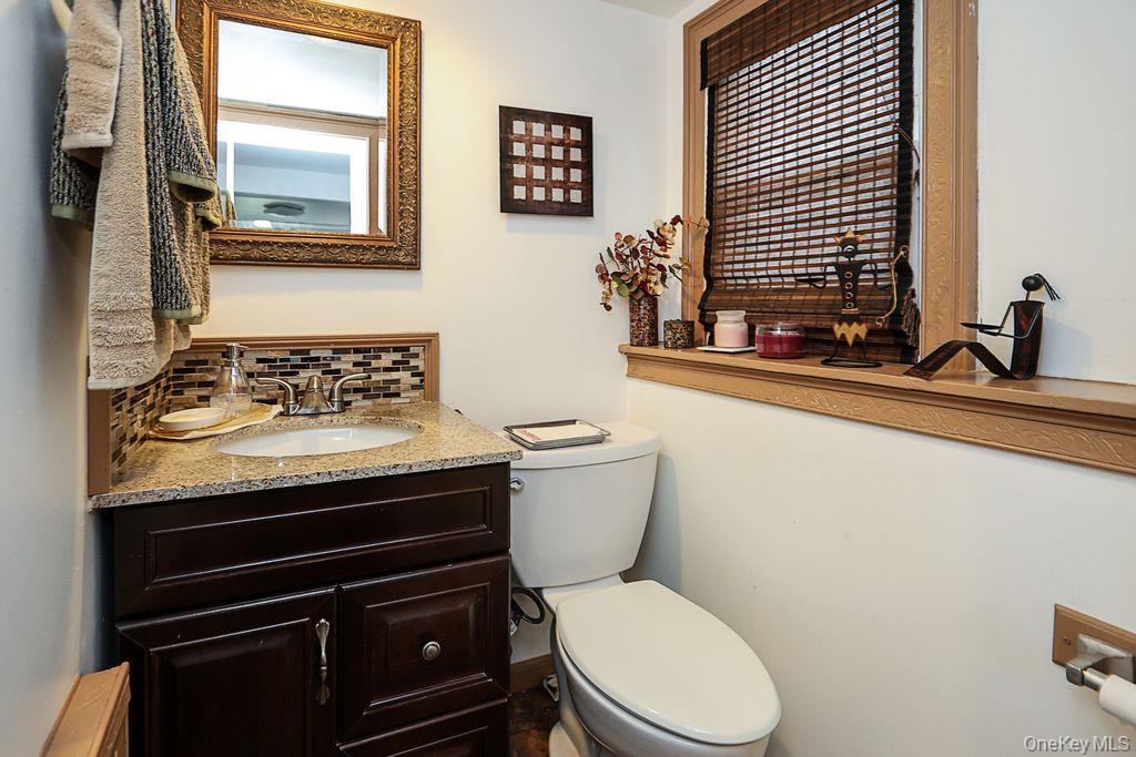 64 Conlon Road Roosevelt, NY 11575 - Photo 15 of 19 a bathroom with a toilet a sink and a window