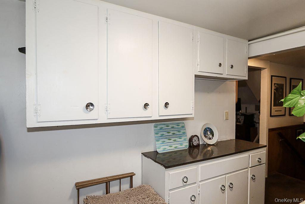 64 Conlon Road Roosevelt, NY 11575 - Photo 16 of 19 a kitchen with white cabinets and a sink