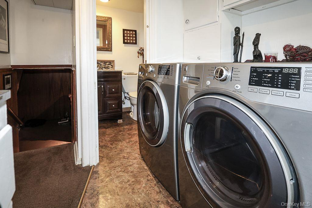 64 Conlon Road Roosevelt, NY 11575 - Photo 17 of 19 a view of washer and dryer with kitchen in the background