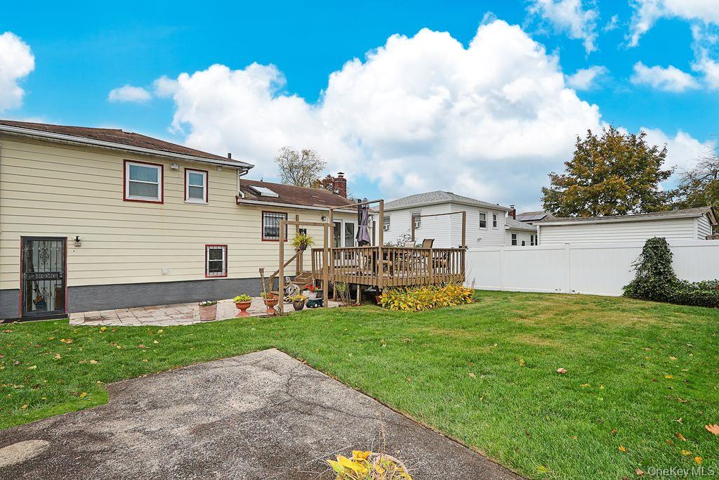 64 Conlon Road Roosevelt, NY 11575 - Photo 19 of 19 a view of a house with a yard and sitting area