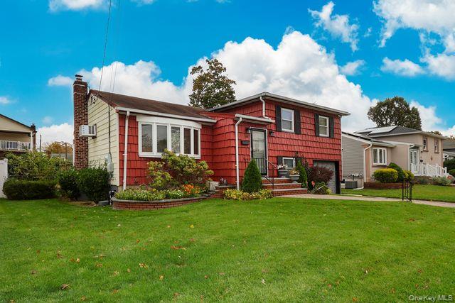 64 Conlon Road Roosevelt, NY 11575 - Photo 3 of 19 a front view of a house with a garden
