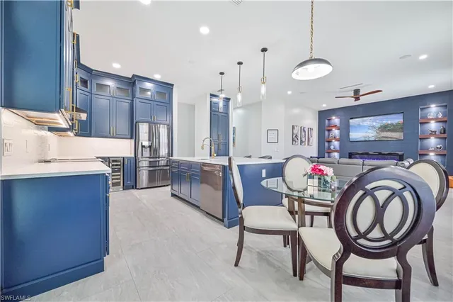 a dining room with furniture and kitchen view