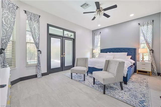 a bed room with a bed and a chair