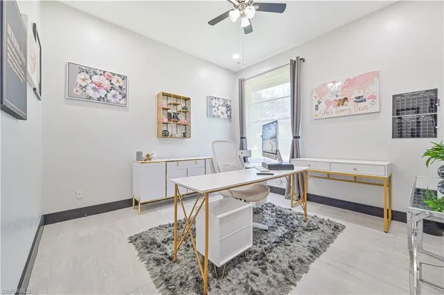a living room with furniture and paintings on the wall