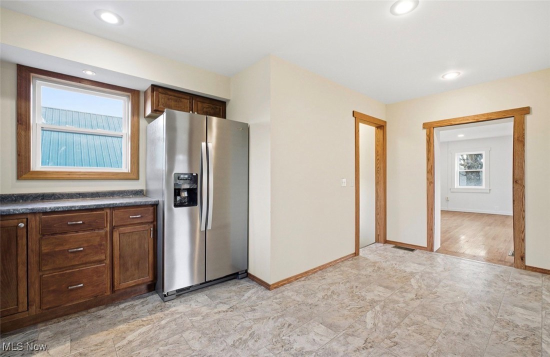 1635 Irish Ridge Road Philo, OH 43771 - Photo 16 of 48 Kitchen with stainless steel refrigerator with ice dispenser, dark countertops, dark brown cabinets, and recessed lighting