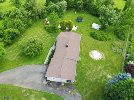 an aerial view of a house with a yard and lake view