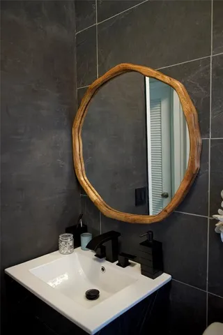 a bathroom with a sink and mirror