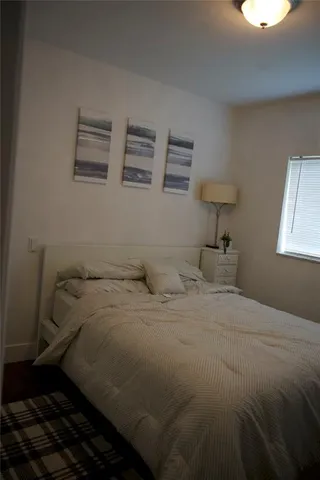 a bedroom with a bed and a lamp