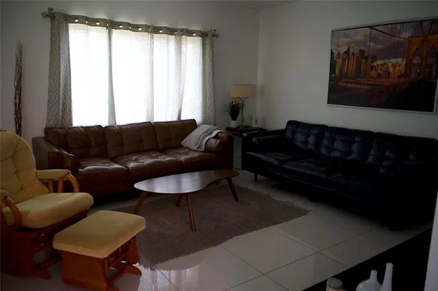 a living room with furniture and a window