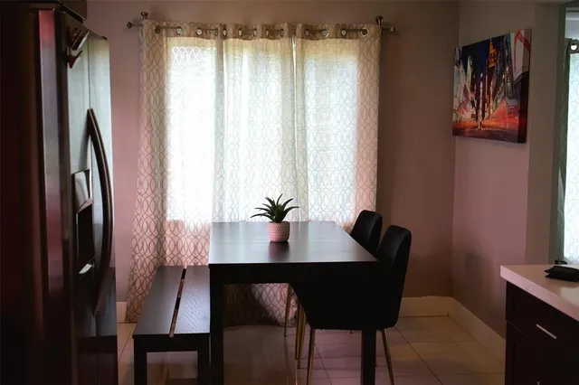 a view of a dining room with furniture and window