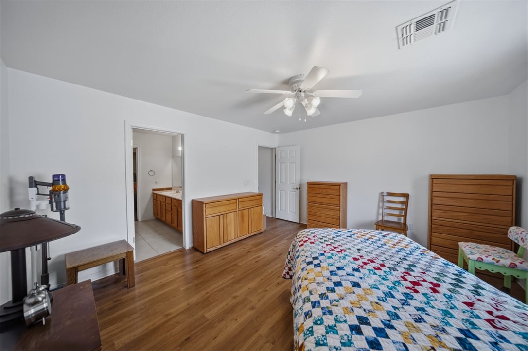 2144 Ridgeview Road Kingman, AZ 86401 - Photo 24 of 49 a bedroom with a bed and a chandelier