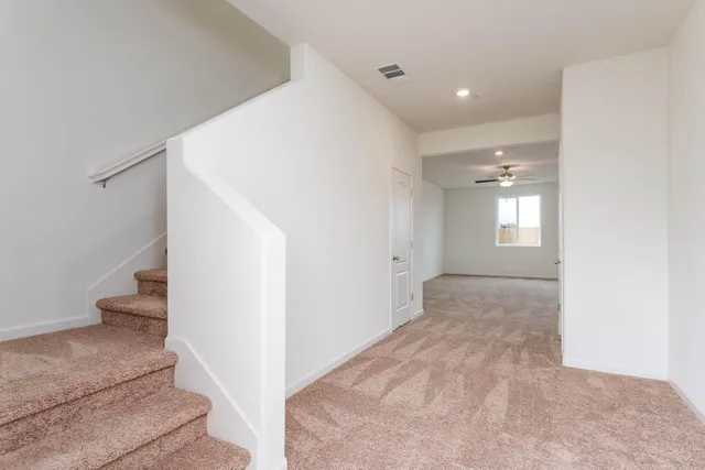 a view of an empty room and stairs