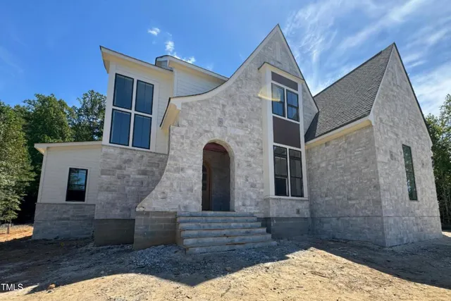 a front view of a house with large windows