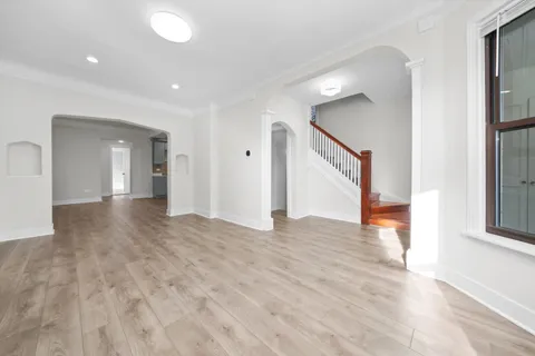 a view of a hallway with wooden floor and closet