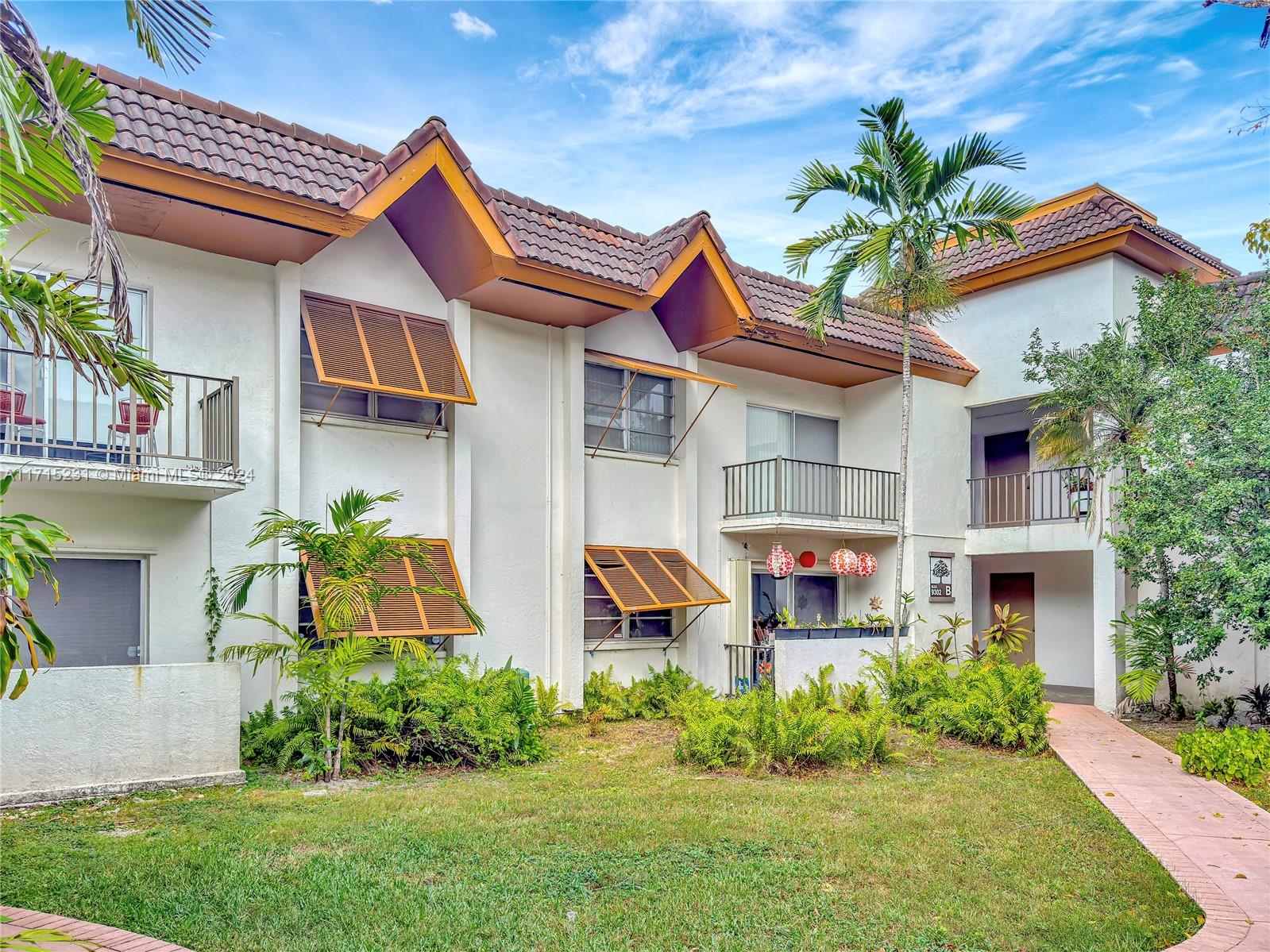9302 Southwest 77th Avenue, Unit B1 Miami, FL 33156 - Photo 11 of 17 a front view of a house with garden