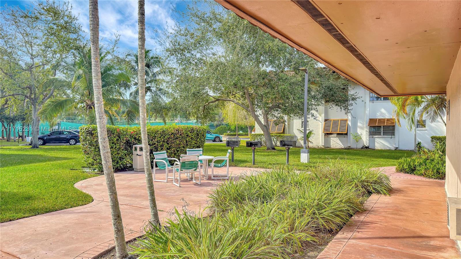 9302 Southwest 77th Avenue, Unit B1 Miami, FL 33156 - Photo 12 of 17 a view of a park with lawn chairs and plants