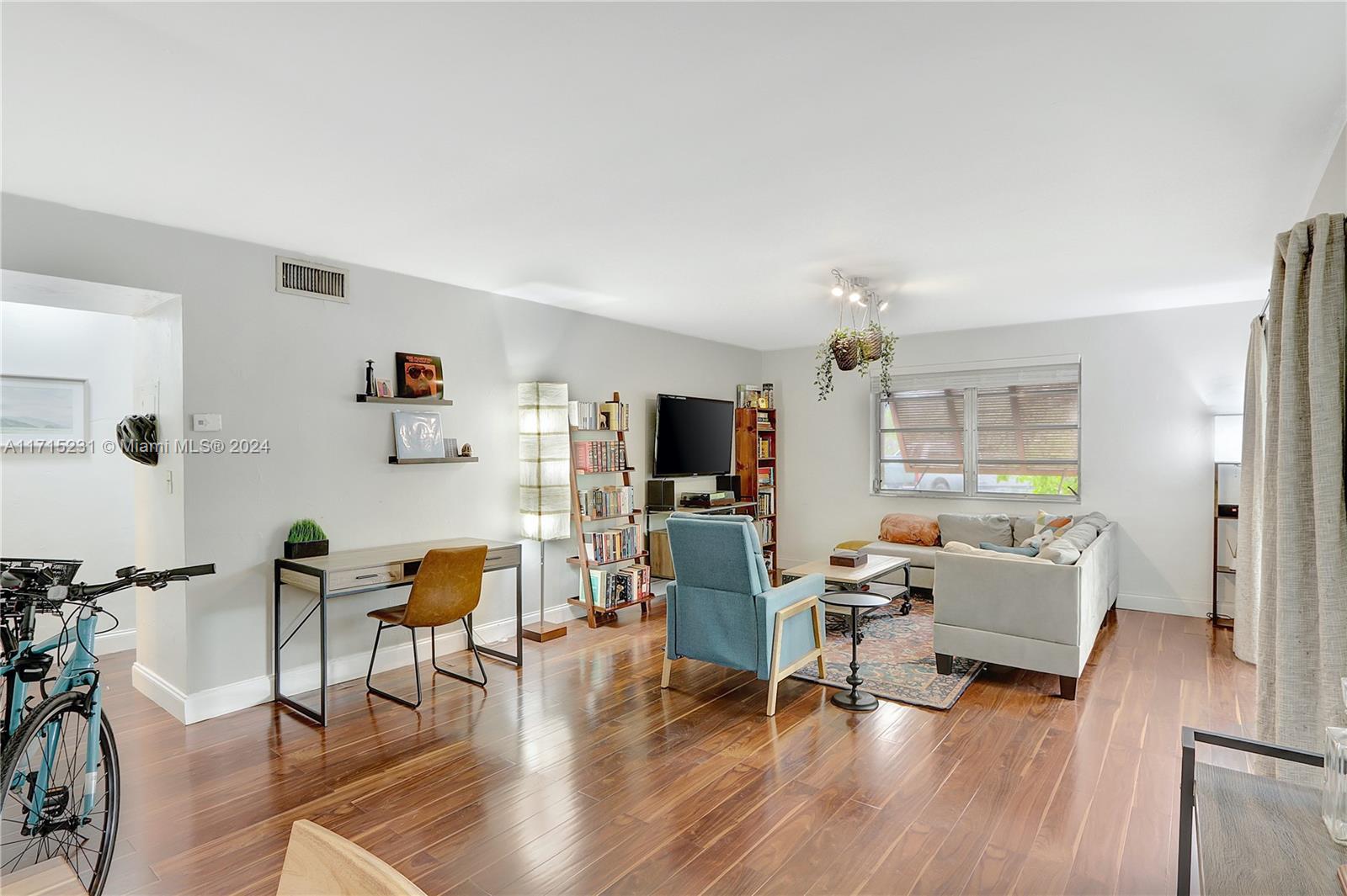 9302 Southwest 77th Avenue, Unit B1 Miami, FL 33156 - Photo 2 of 17 a living room with furniture and a flat screen tv