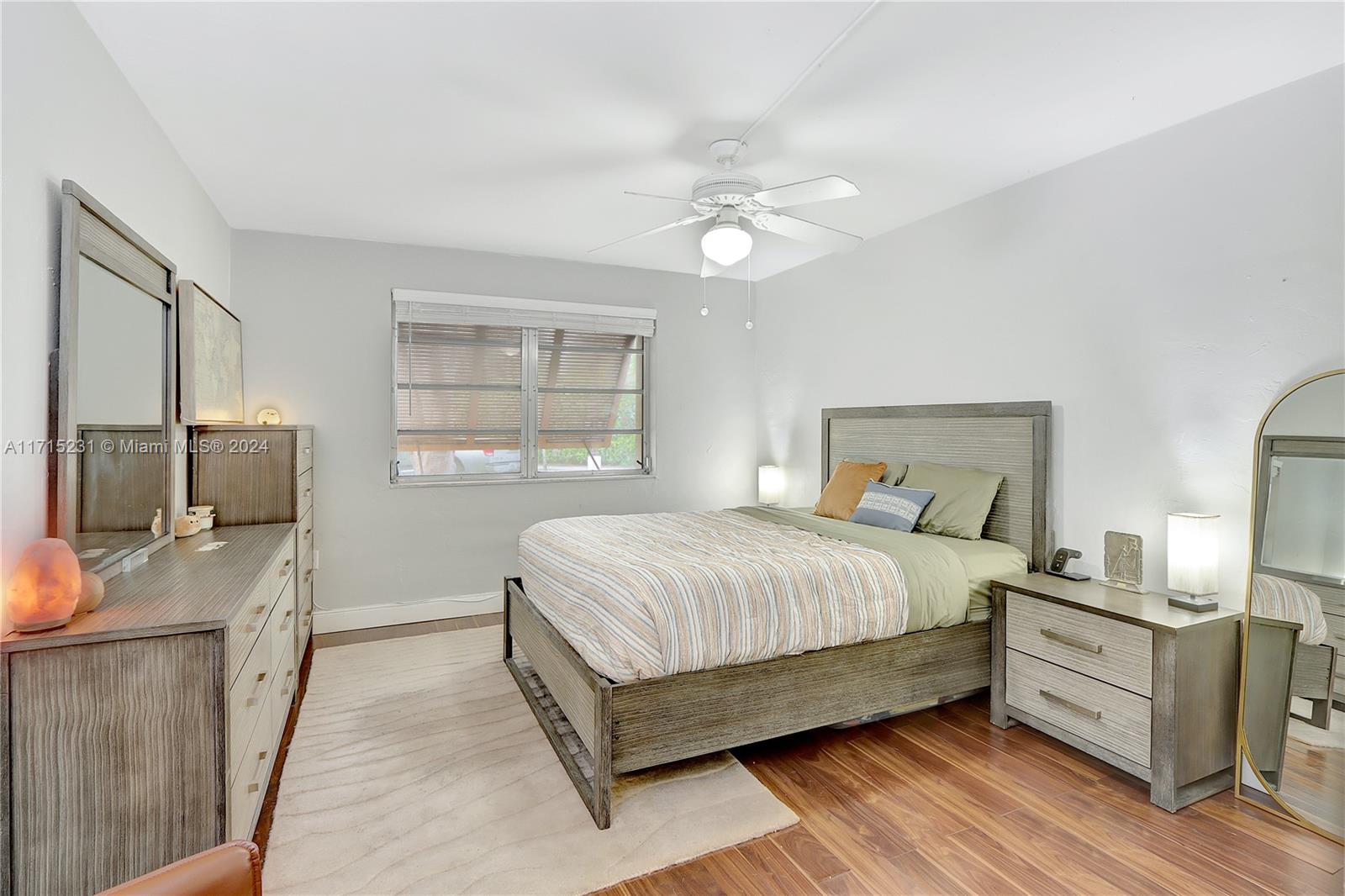 9302 Southwest 77th Avenue, Unit B1 Miami, FL 33156 - Photo 6 of 17 a bedroom with a bed flat screen tv and window