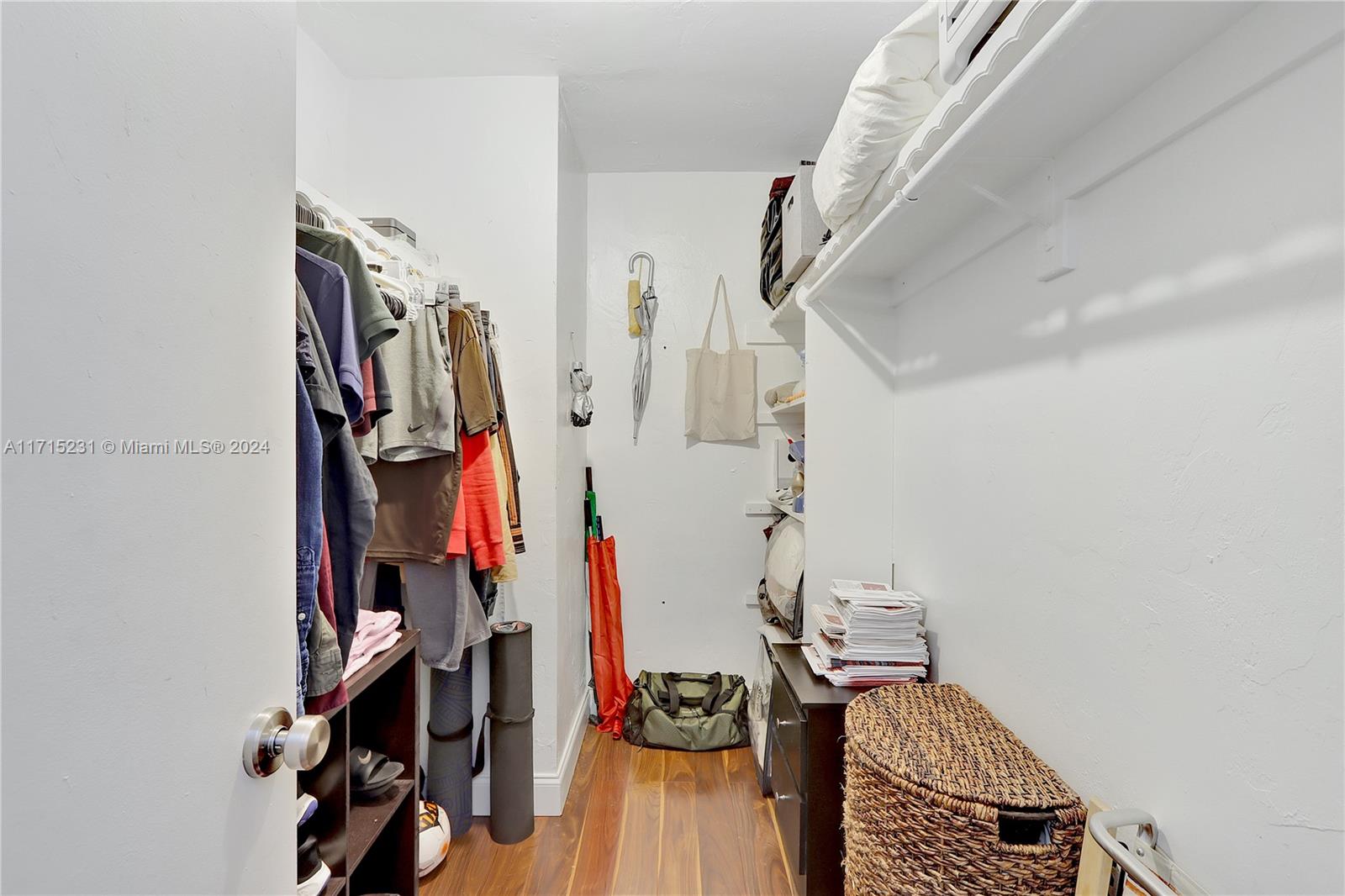 9302 Southwest 77th Avenue, Unit B1 Miami, FL 33156 - Photo 10 of 17 a view of walk in closet with clothes and shoes