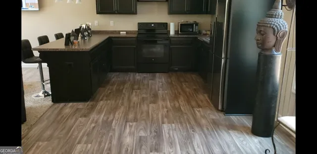 a kitchen with a sink and refrigerator