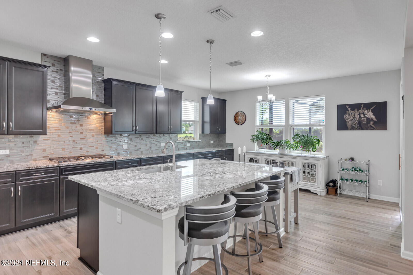 126 Firefly Trace St. Augustine, FL 32092 - Photo 11 of 54 a kitchen with granite countertop kitchen island cabinets and wooden floor