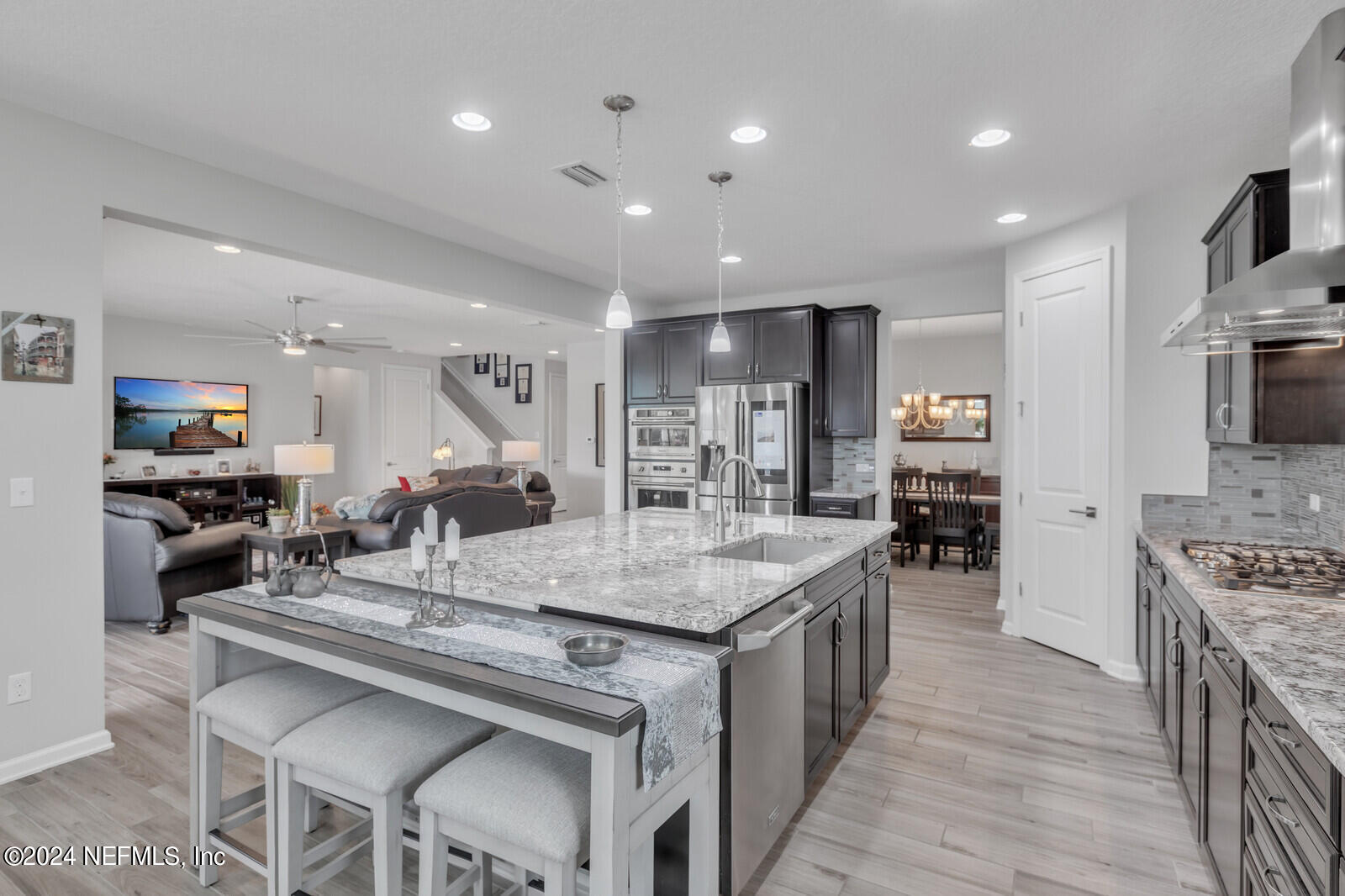 126 Firefly Trace St. Augustine, FL 32092 - Photo 12 of 54 a kitchen with stainless steel appliances granite countertop island wooden cabinets and refrigerator