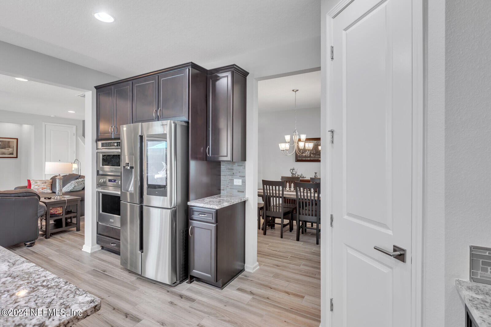 126 Firefly Trace St. Augustine, FL 32092 - Photo 15 of 54 a kitchen with stainless steel appliances a refrigerator and wooden floor