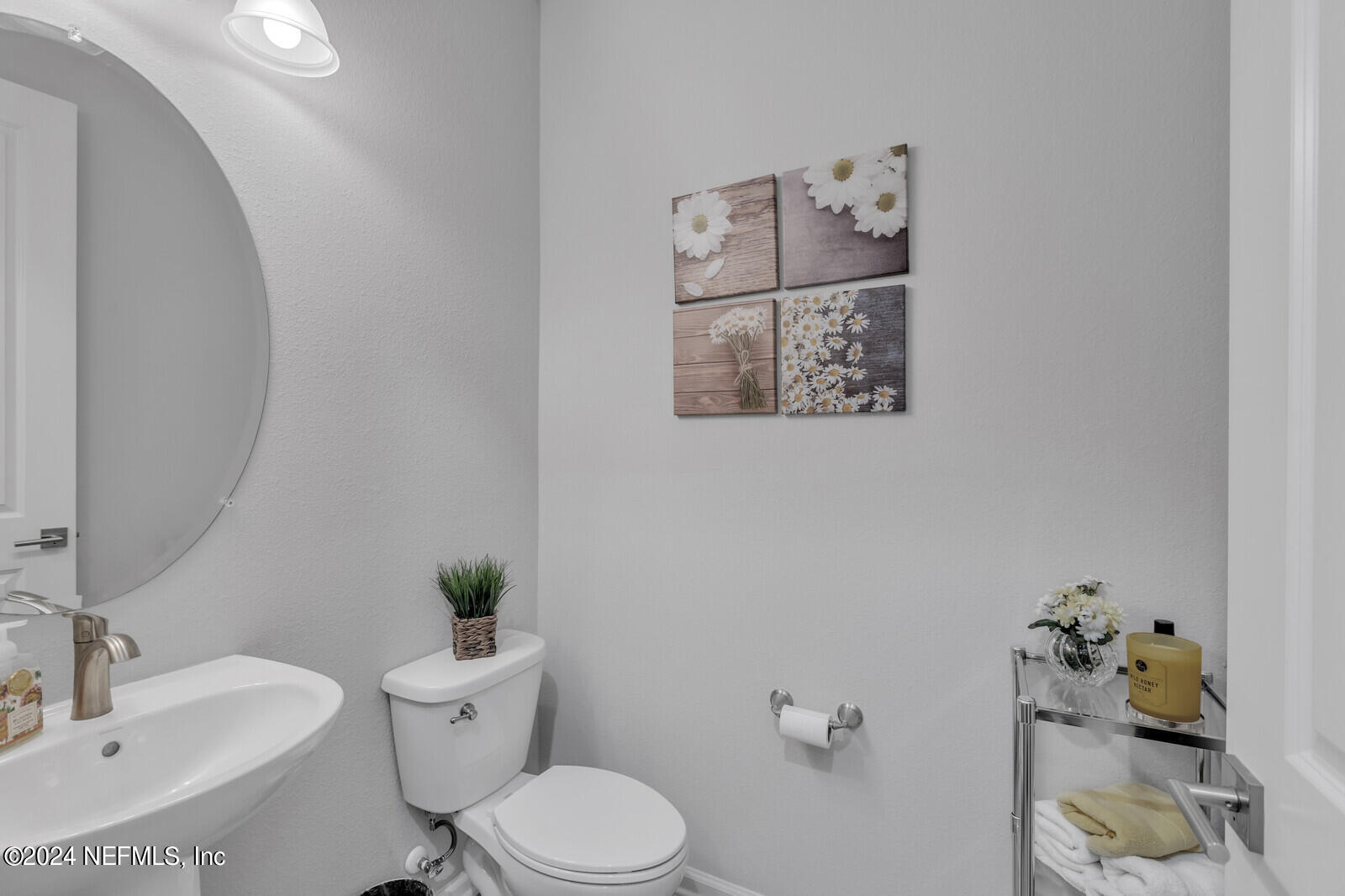 126 Firefly Trace St. Augustine, FL 32092 - Photo 19 of 54 a white toilet sitting next to a bathroom sink