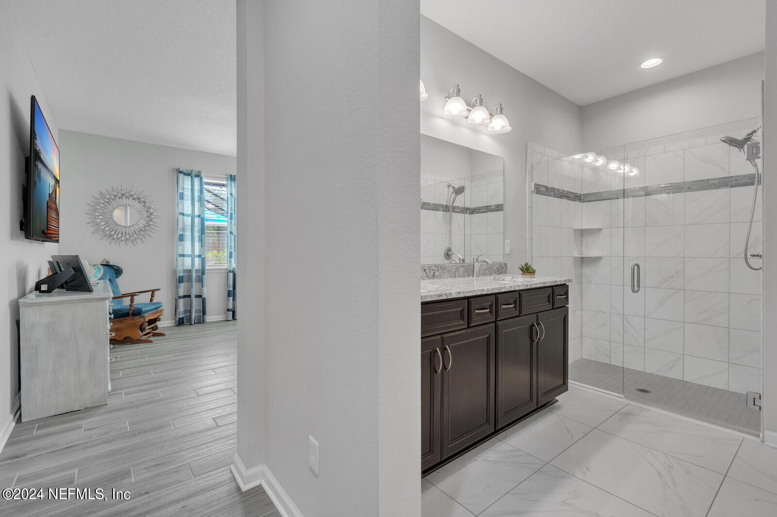 126 Firefly Trace St. Augustine, FL 32092 - Photo 21 of 54 a bathroom with a sink a vanity a large mirror and shower
