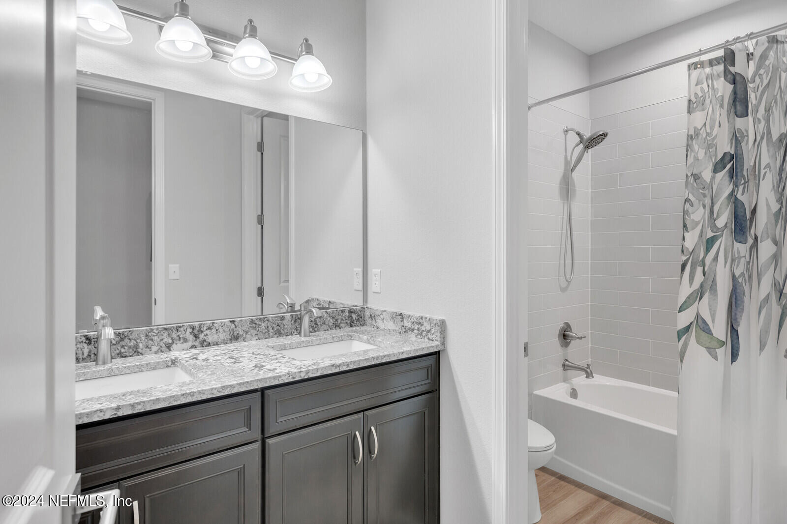 126 Firefly Trace St. Augustine, FL 32092 - Photo 25 of 54 a bathroom with a granite countertop sink a toilet and shower