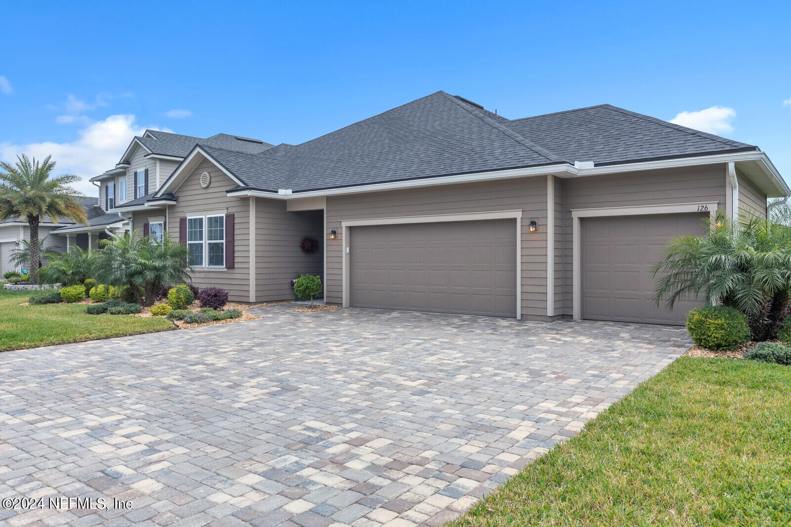 126 Firefly Trace St. Augustine, FL 32092 - Photo 5 of 54 a front view of a house with a yard and garage