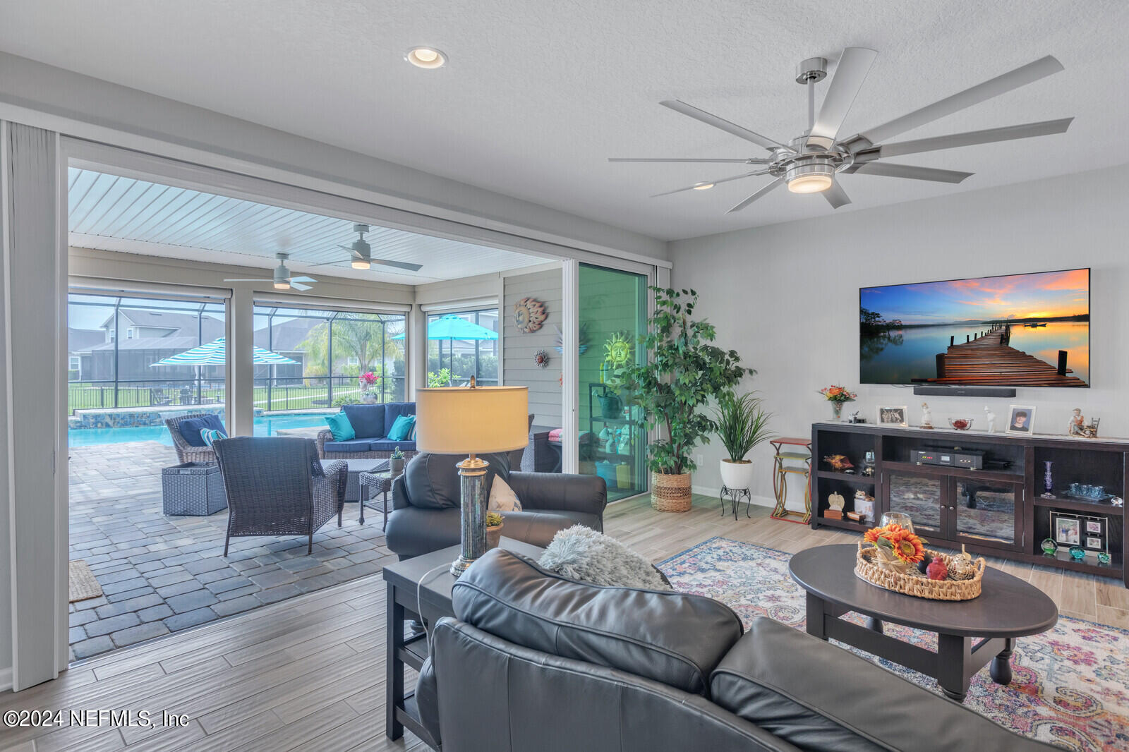 126 Firefly Trace St. Augustine, FL 32092 - Photo 10 of 54 a living room with furniture and a flat screen tv with wooden floor