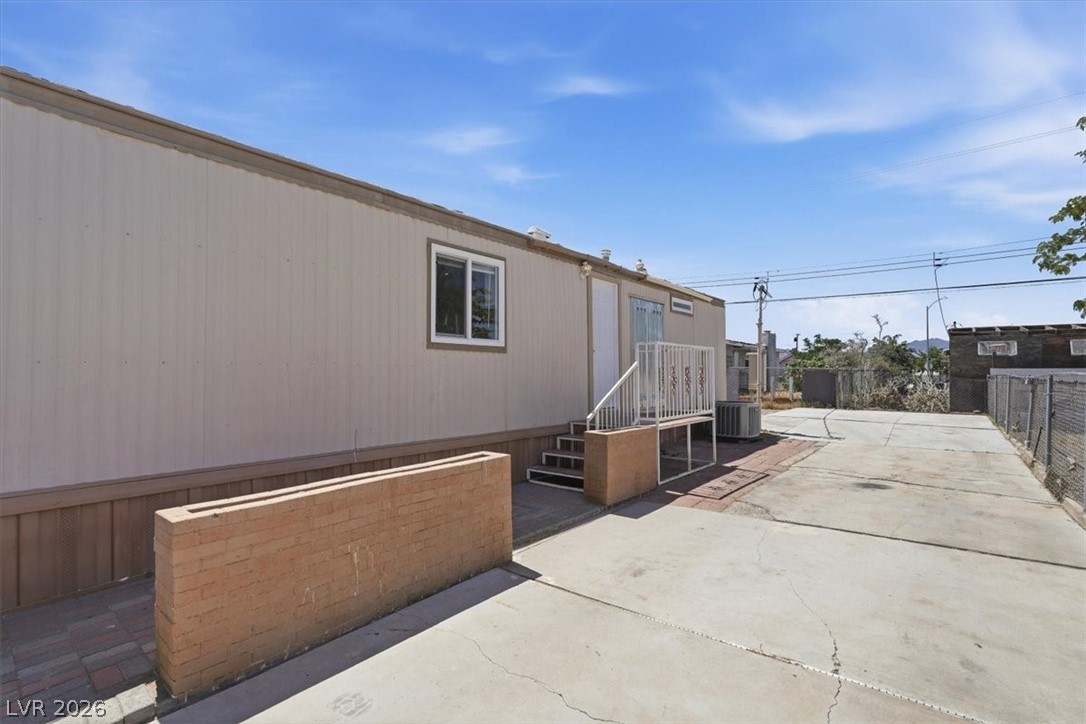 283 Aztec Lane Henderson, NV 89015 - Photo 3 of 21 A well-maintained manufactured home with ample paved yard space awaits your personal touch.
