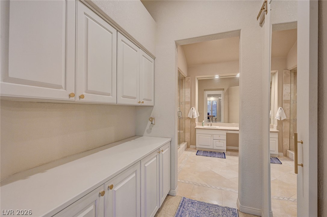 7995 Rio Rico Drive Las Vegas, NV 89113 - Photo 30 of 92 Ample storage solutions and elegant tile flooring define this well-appointed bathroom space.