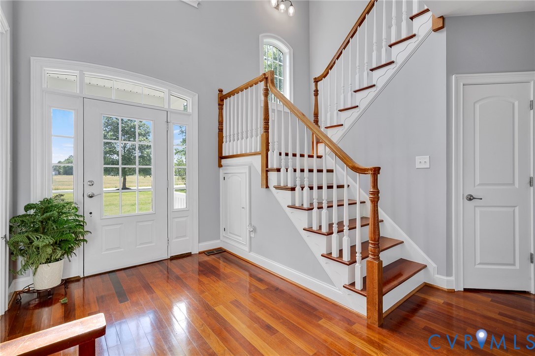 17170 Templeton Road Disputanta, VA 23842 - Photo 4 of 27 a view of an entryway with wooden floor and front door