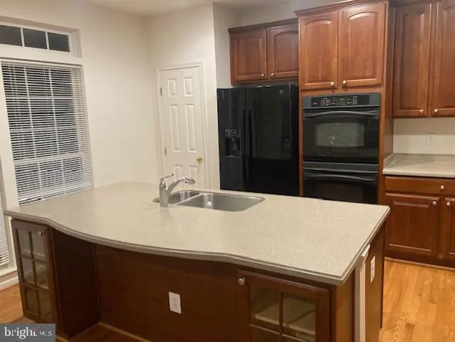a kitchen with a sink appliances and cabinets
